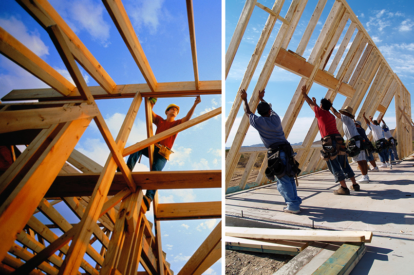 Carpenter measuring frame of unfinished house, low angle view